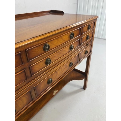 424 - Reproduction antique Mahogany sideboard with nine drawers and shelf under