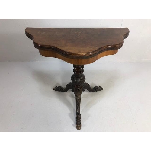 425 - Antique folding card table with book match veneer, on carved tripod base opening to reveal green bai... 