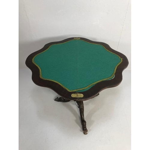 425 - Antique folding card table with book match veneer, on carved tripod base opening to reveal green bai... 