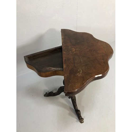 425 - Antique folding card table with book match veneer, on carved tripod base opening to reveal green bai... 