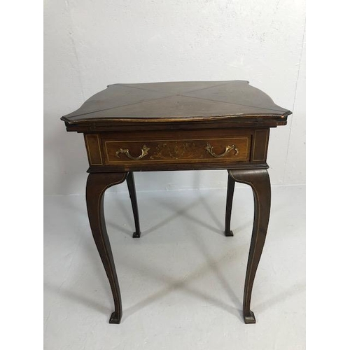 426 - Edwardian games table with inlay top, on serpentine legs, the four triangular quarters of the top hi... 