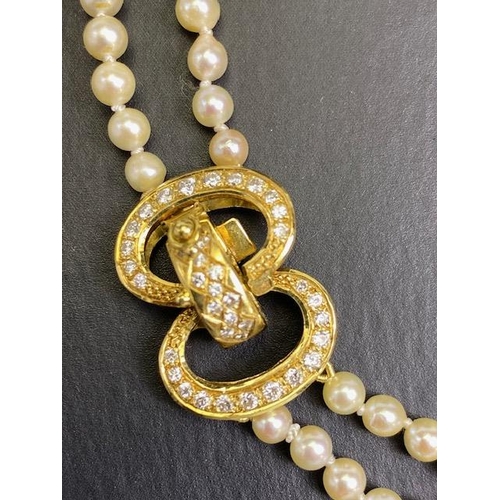 55 - cultured pearls with 18ct gold and Diamond clasp, double strand necklace of graduated cultured pearl... 