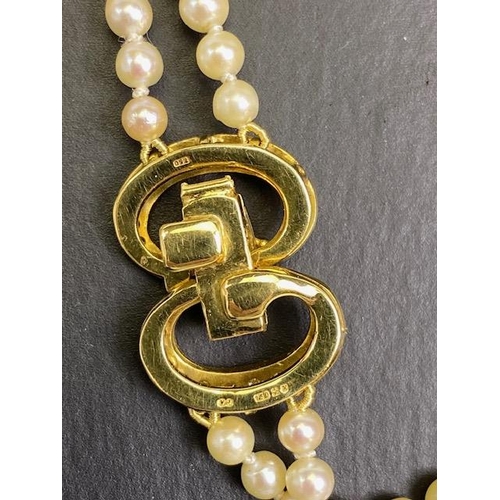 55 - cultured pearls with 18ct gold and Diamond clasp, double strand necklace of graduated cultured pearl... 