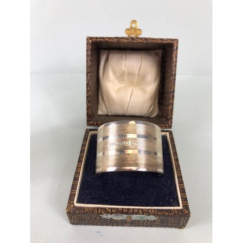 62 - Hallmarked silver rimmed horn toast cup and a cased hallmarked silver napkin ring (46.5g)