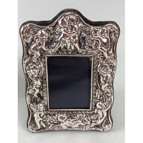 69 - Silver hallmarked photo frames, one round of art nouveau design 14cm across, (picture 10cm), one Obl... 