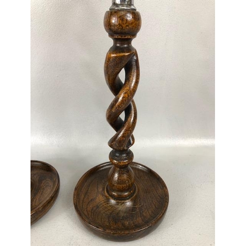 77 - Wooden twisted stem / open barley twist candle sticks with silver coloured metal mounts each approx ... 