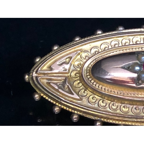 30a - 9ct Gold mourning brooch set with seed pearls and a central Garnet approx 44mm wide & 3.5g