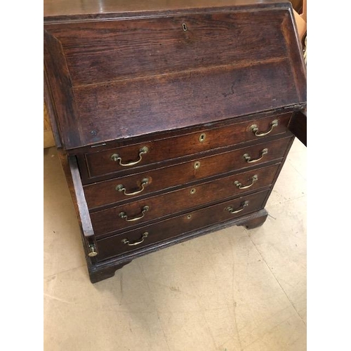 100 - Antique Georgian Oak Bureau with four drawers and fall front opening to pigeon holes and small drawe... 