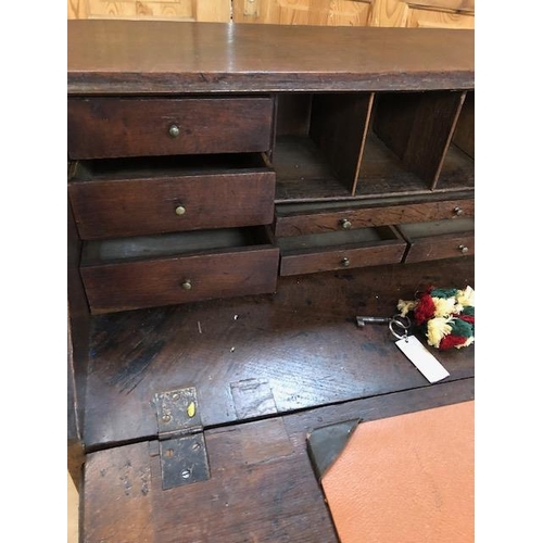 100 - Antique Georgian Oak Bureau with four drawers and fall front opening to pigeon holes and small drawe... 