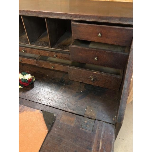 100 - Antique Georgian Oak Bureau with four drawers and fall front opening to pigeon holes and small drawe... 