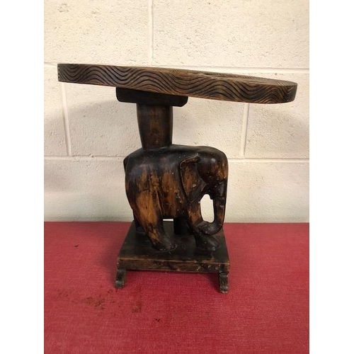 138 - Carved wooden elephant stool approximately 37cm high,  tribal style glass plate and a carved African... 