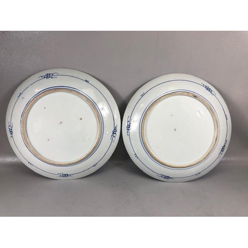 166 - Chinese blue and white ceramic charger plates, both decorated with a  landscape, impressed marks to ... 