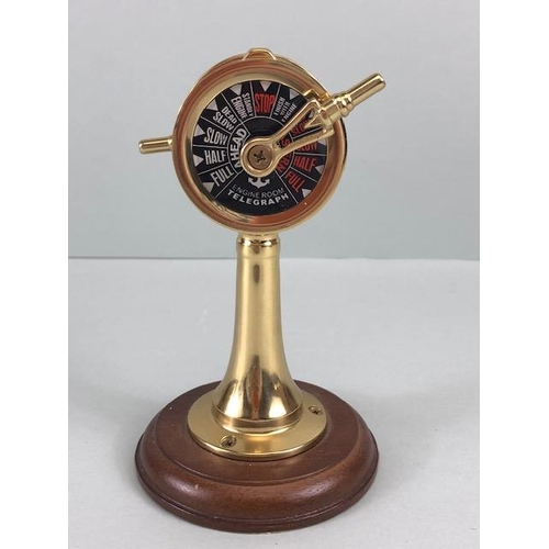 167 - Ships style clock with quartz movement mounted on a wooden plaque along with a desk model of a ships... 