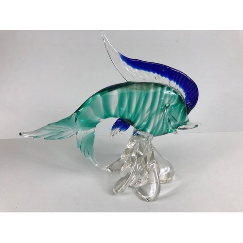 187 - Art glass, Murano glass fish on stylised swirling water in blue and sea green approximately 27cm hig... 