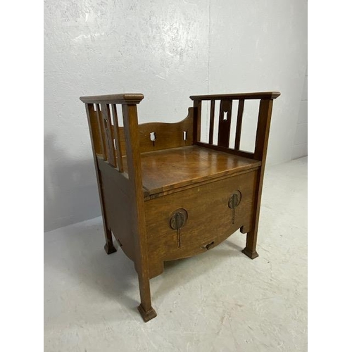 220 - Arts and Crafts commode chair with carvings and pierced decoration and original ceramics