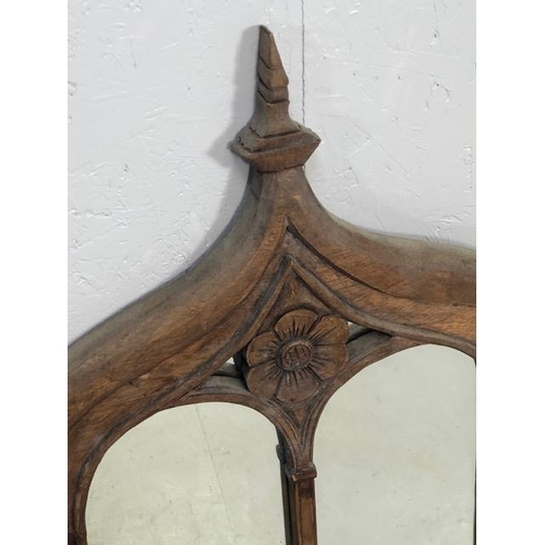 223 - Craved ecclesiastical wooden framed mirror  with a central carved rose and arched detailing approx 1... 