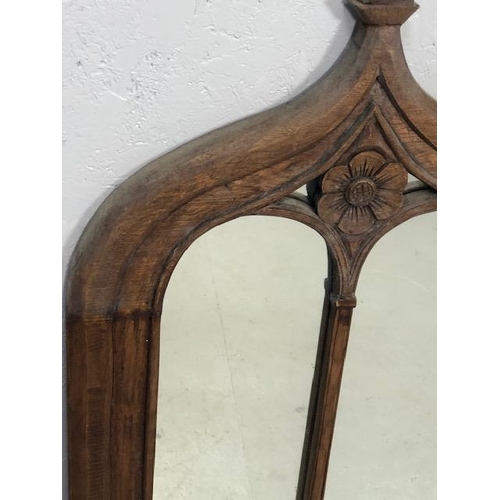 223 - Craved ecclesiastical wooden framed mirror  with a central carved rose and arched detailing approx 1... 