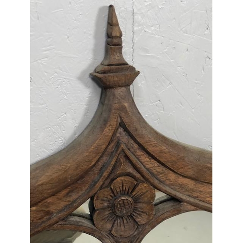 223 - Craved ecclesiastical wooden framed mirror  with a central carved rose and arched detailing approx 1... 