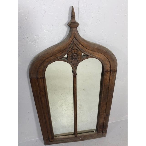 223 - Craved ecclesiastical wooden framed mirror  with a central carved rose and arched detailing approx 1... 