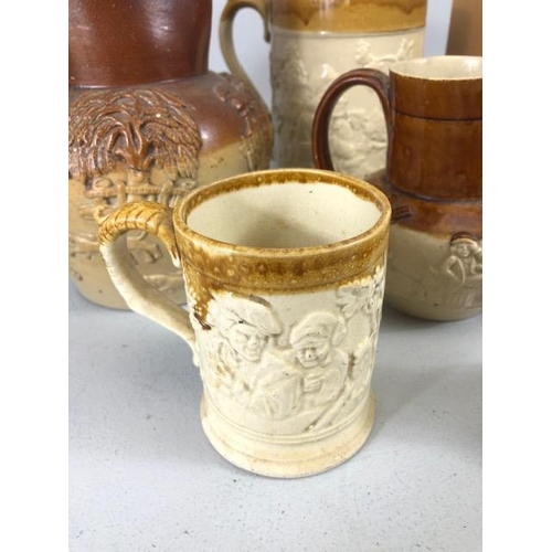 265 - Collection of salt glaze jugs and cider mugs along with a book shape bottle