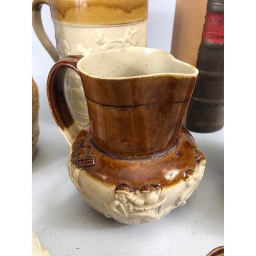 265 - Collection of salt glaze jugs and cider mugs along with a book shape bottle