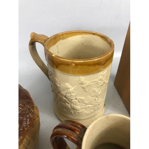 265 - Collection of salt glaze jugs and cider mugs along with a book shape bottle