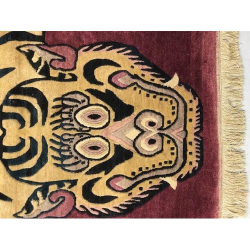 274 - Oriental Rugs, Chinese or Tibetan tiger rug, hand knotted wool, tiger set against a magenta back gro... 