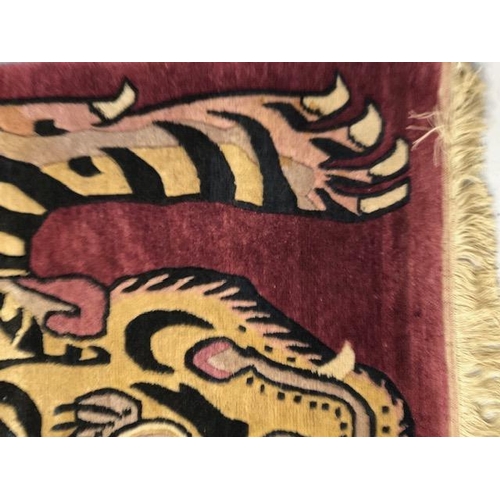 274 - Oriental Rugs, Chinese or Tibetan tiger rug, hand knotted wool, tiger set against a magenta back gro... 