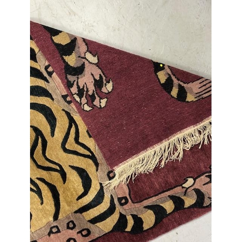 274 - Oriental Rugs, Chinese or Tibetan tiger rug, hand knotted wool, tiger set against a magenta back gro... 