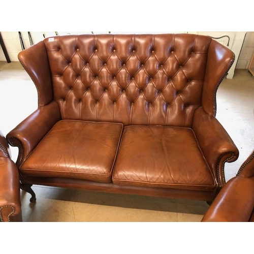 282 - Vintage three piece leather suite,  comprising of button wing back 2 seater sofa and a  pair of matc... 