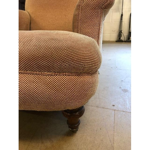 283 - Antique furniture, Howard style deep seated  arm chair, turned front legs with brass casters, has be... 