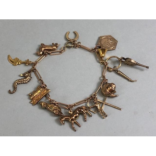 29 - 9ct Gold Charm bracelet with approx 11 charms to include a Dachshund, race horse, seahorse, horse sh... 