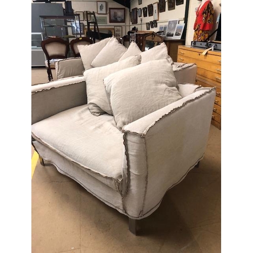 291 - Modern two seater sofa and matching arm chair by Designers Guild, with reverse  seam covers on metal... 