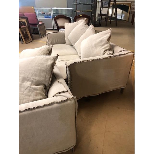 291 - Modern two seater sofa and matching arm chair by Designers Guild, with reverse  seam covers on metal... 