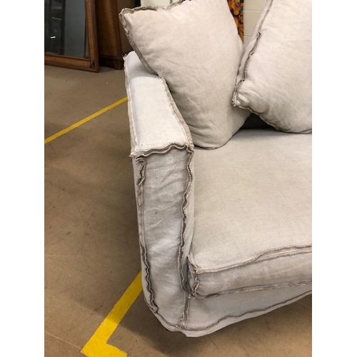 291 - Modern two seater sofa and matching arm chair by Designers Guild, with reverse  seam covers on metal... 