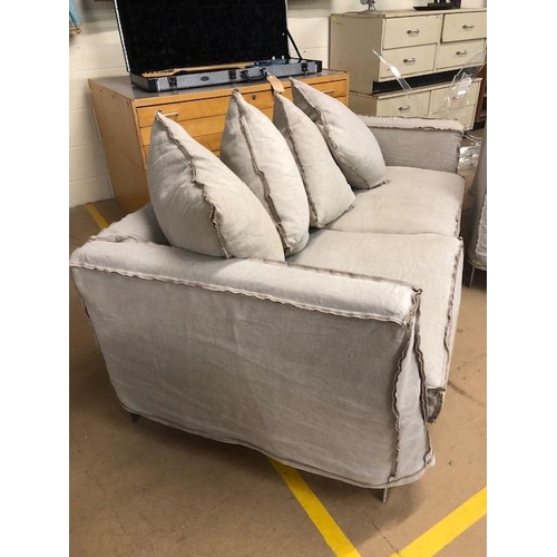 291 - Modern two seater sofa and matching arm chair by Designers Guild, with reverse  seam covers on metal... 