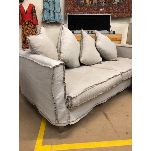 291 - Modern two seater sofa and matching arm chair by Designers Guild, with reverse  seam covers on metal... 