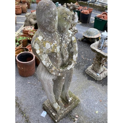 311 - Concrete garden statue in the style of Barbara Hepworth, of two figures embracing, approx 118cm tall