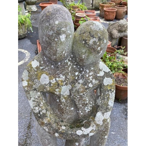 311 - Concrete garden statue in the style of Barbara Hepworth, of two figures embracing, approx 118cm tall