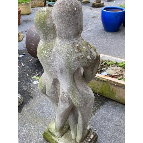 311 - Concrete garden statue in the style of Barbara Hepworth, of two figures embracing, approx 118cm tall