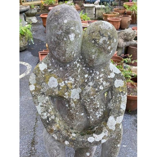 311 - Concrete garden statue in the style of Barbara Hepworth, of two figures embracing, approx 118cm tall