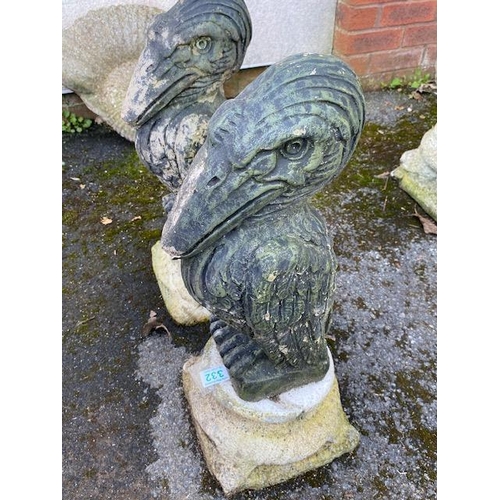 332 - Pair of concrete garden pelicans on plinths, approx 56cm tall