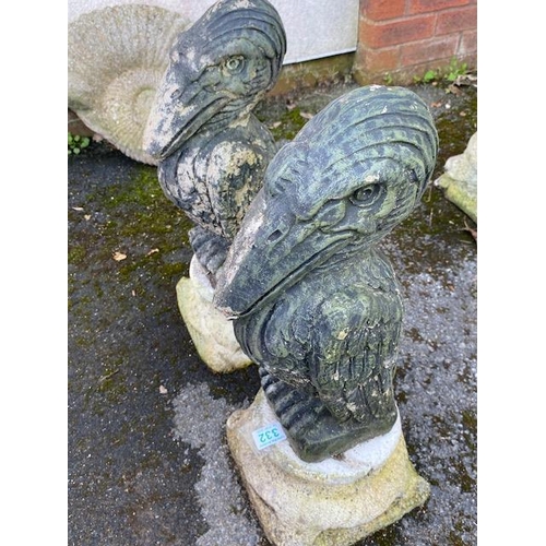 332 - Pair of concrete garden pelicans on plinths, approx 56cm tall