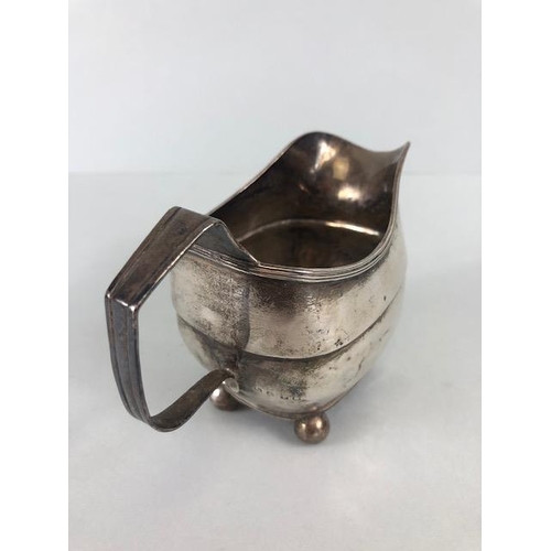 52 - Silver Georgian Creamer jug hallmarked for London 1814 on four ball feet approx 9cm tall and 101g