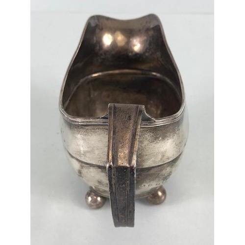 52 - Silver Georgian Creamer jug hallmarked for London 1814 on four ball feet approx 9cm tall and 101g