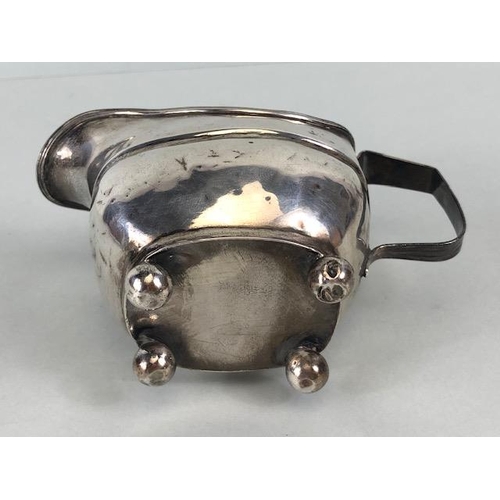 52 - Silver Georgian Creamer jug hallmarked for London 1814 on four ball feet approx 9cm tall and 101g