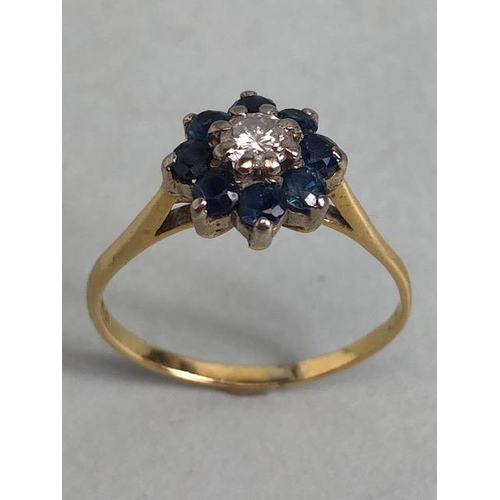 70 - 18ct yellow gold ring of daisy design, the  central diamond surrounded with 8 sapphires approximatel... 