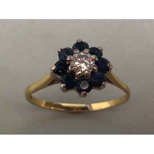 70 - 18ct yellow gold ring of daisy design, the  central diamond surrounded with 8 sapphires approximatel... 