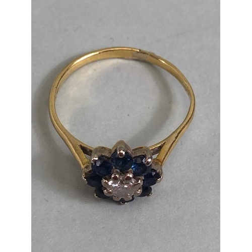 70 - 18ct yellow gold ring of daisy design, the  central diamond surrounded with 8 sapphires approximatel... 