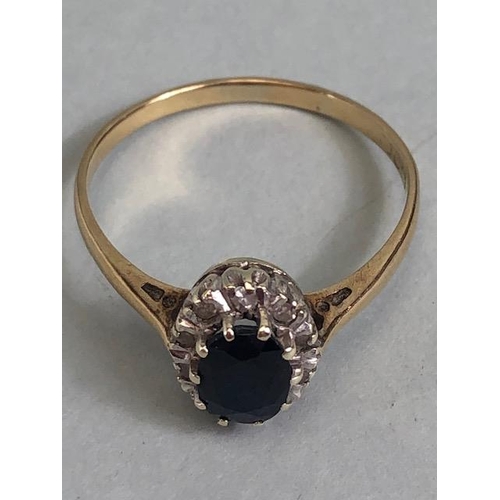 76 - 9ct gold ring set with an oval sapphire surrounded with diamonds approximately size R  and 2.1g